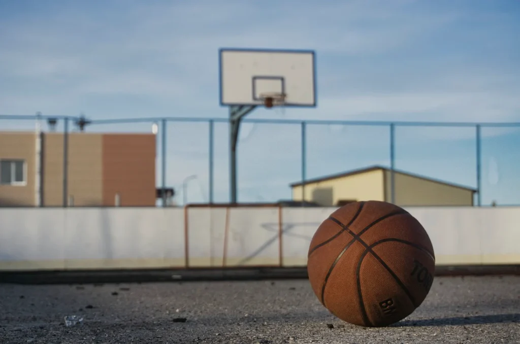 Asphalt court with extra tough acrylic sports surfacing used for basketball and jogging surfaces.